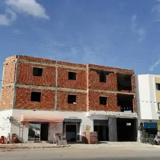 Unfinished building with leased shop on the main road, Houmt Souk